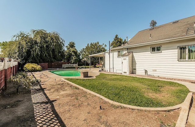 view of yard with a patio area and a fenced in pool