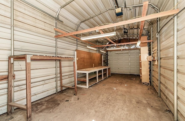 garage with wood walls and a garage door opener