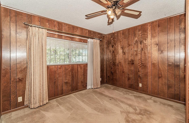 unfurnished room with wood walls and a textured ceiling