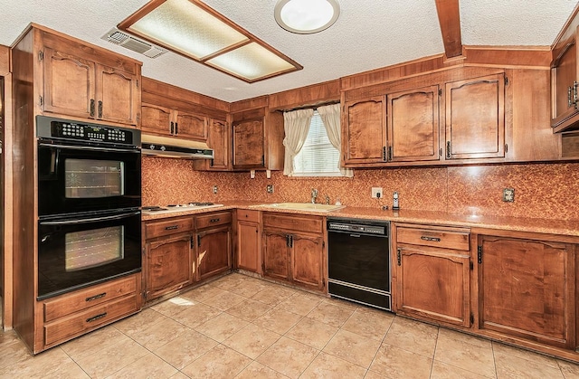 kitchen featuring tasteful backsplash, sink, black appliances, and a textured ceiling