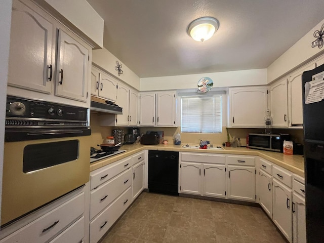 kitchen featuring black appliances, sink, and white cabinets