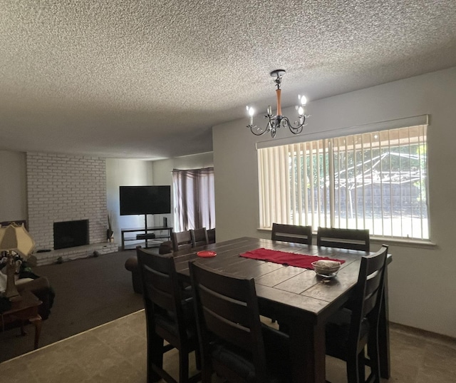 dining area featuring a textured ceiling, a brick fireplace, and a chandelier