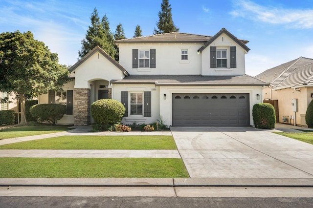 front facade featuring a front yard and a garage