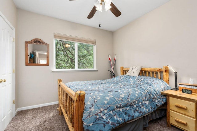 bedroom with ceiling fan and dark carpet