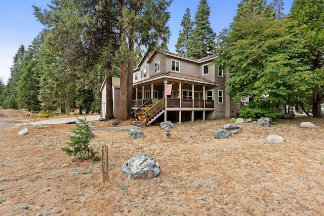 rear view of house featuring a porch