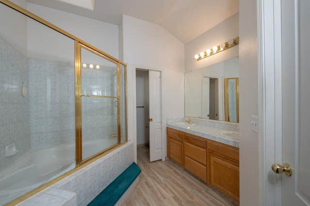 bathroom with vanity, shower / bath combination with glass door, hardwood / wood-style flooring, and lofted ceiling