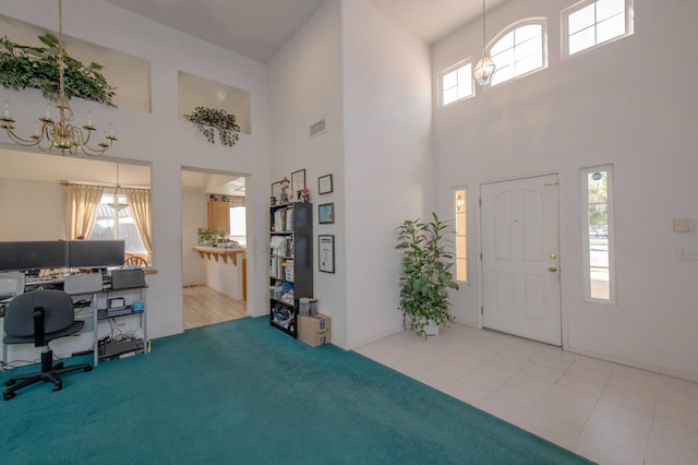 carpeted foyer entrance with a high ceiling