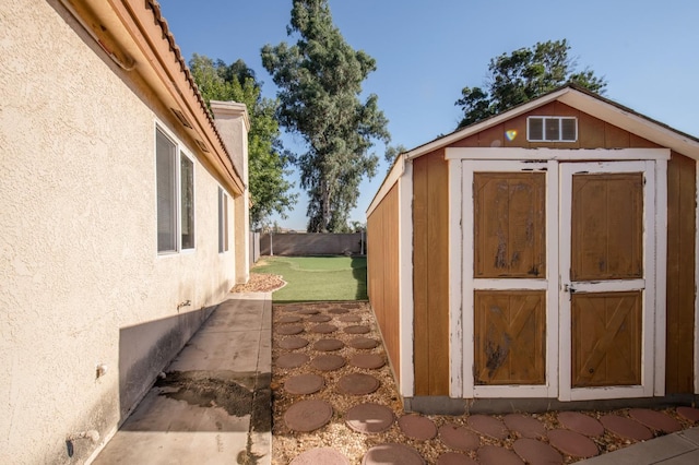 view of outbuilding featuring a lawn