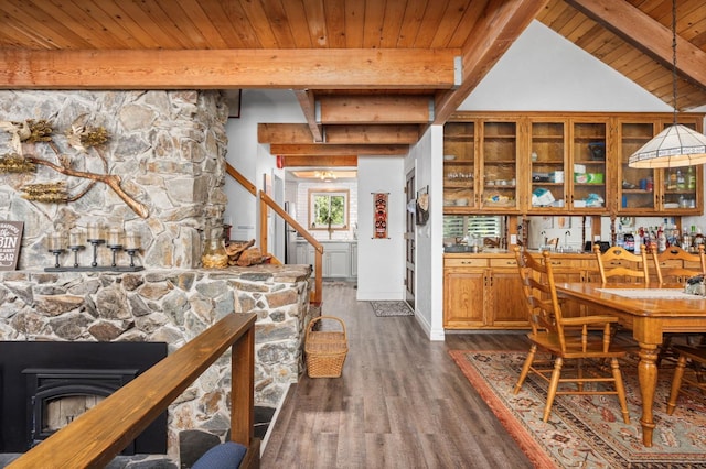 interior space with dark hardwood / wood-style floors, wooden ceiling, and lofted ceiling with beams