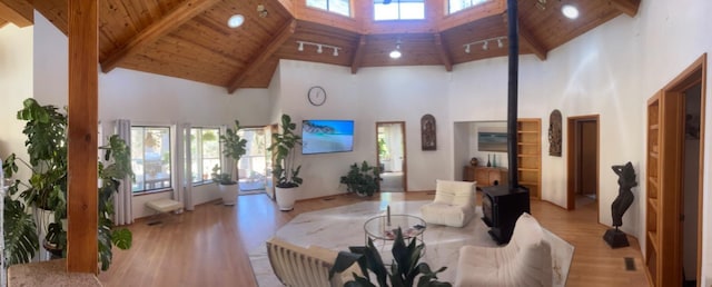 living room with beamed ceiling, light hardwood / wood-style floors, wood ceiling, and high vaulted ceiling