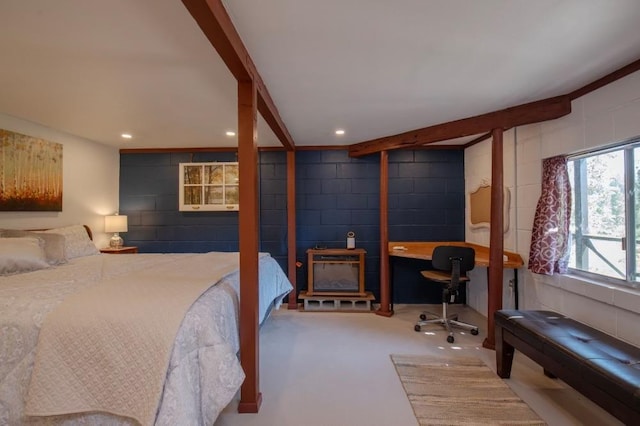 bedroom with beamed ceiling and concrete flooring