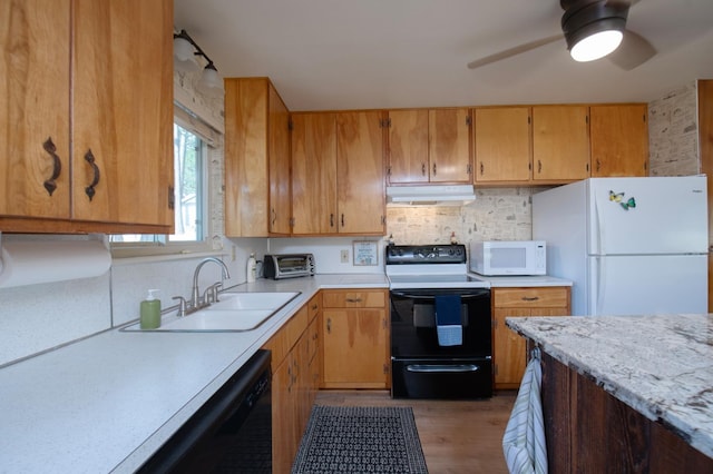 kitchen with backsplash, ceiling fan, light wood-type flooring, black appliances, and sink