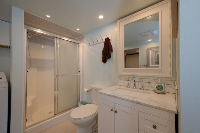 bathroom with a shower with door, vanity, toilet, and tasteful backsplash