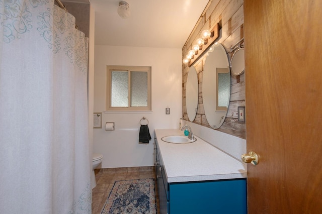 bathroom featuring vanity, toilet, and tile patterned flooring