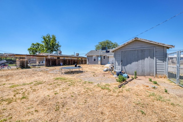 view of yard featuring a storage shed and a trampoline