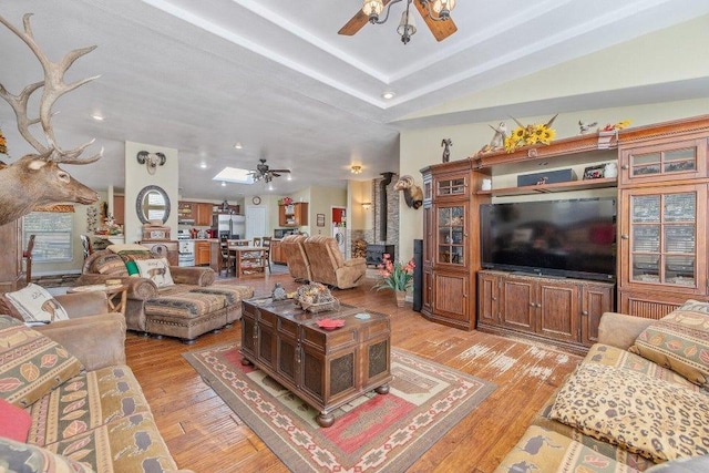 living room with light hardwood / wood-style flooring and ceiling fan