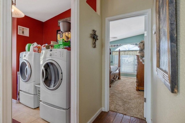 laundry room with independent washer and dryer and light colored carpet