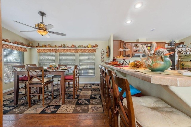 dining space with a ceiling fan, lofted ceiling, baseboards, recessed lighting, and hardwood / wood-style floors