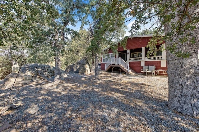 view of yard with covered porch