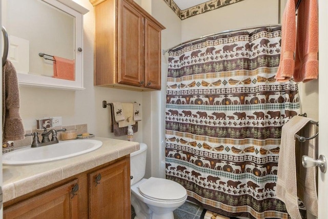 bathroom featuring toilet, vanity, and a shower with shower curtain