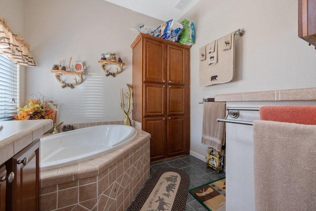 bathroom featuring visible vents, tile patterned flooring, and a garden tub