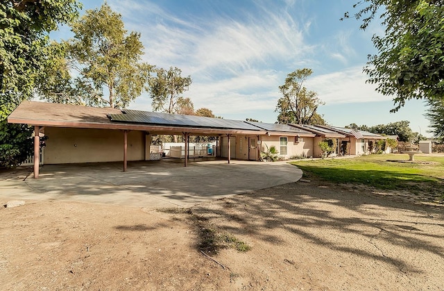 view of front of house with a front yard and a carport