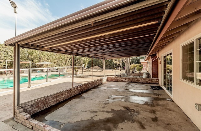 view of patio with a fenced in pool