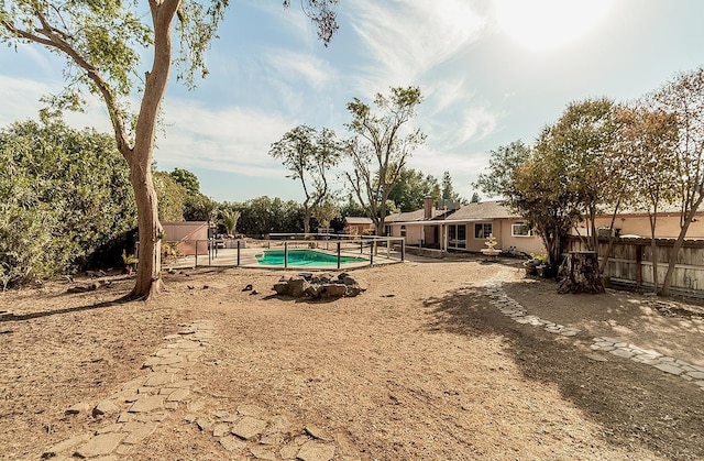 view of yard with a fenced in pool