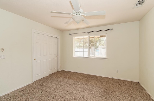 unfurnished bedroom with carpet floors, ceiling fan, and a closet