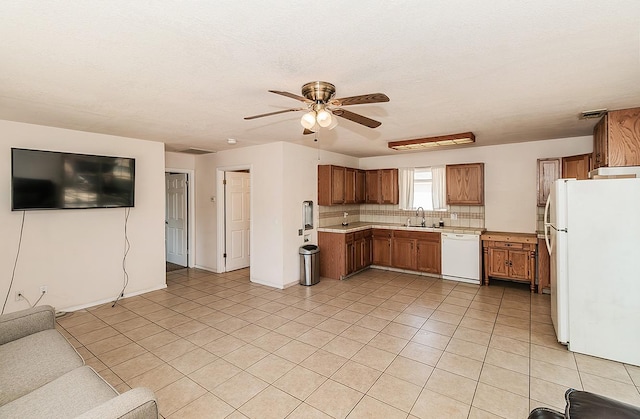 kitchen featuring sink, white appliances, ceiling fan, light tile patterned floors, and backsplash