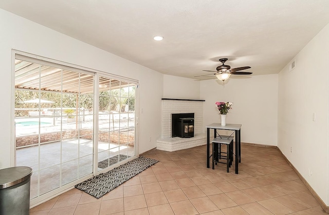 living room featuring ceiling fan and light tile patterned flooring