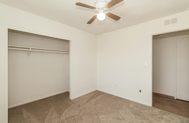 unfurnished bedroom with ceiling fan, light colored carpet, and a closet