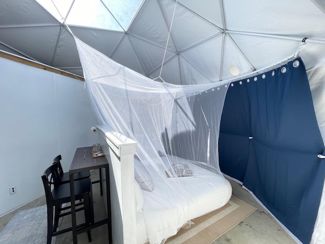 bedroom featuring concrete floors