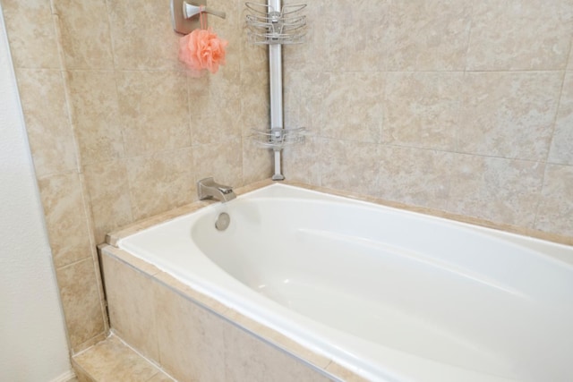 bathroom featuring tiled tub