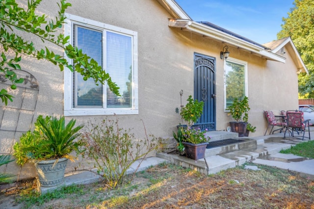 entrance to property featuring a patio