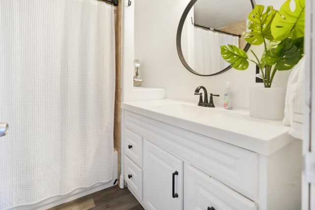 bathroom featuring vanity, hardwood / wood-style flooring, and shower / bathtub combination with curtain