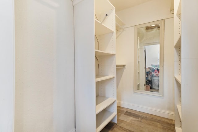 spacious closet featuring hardwood / wood-style flooring