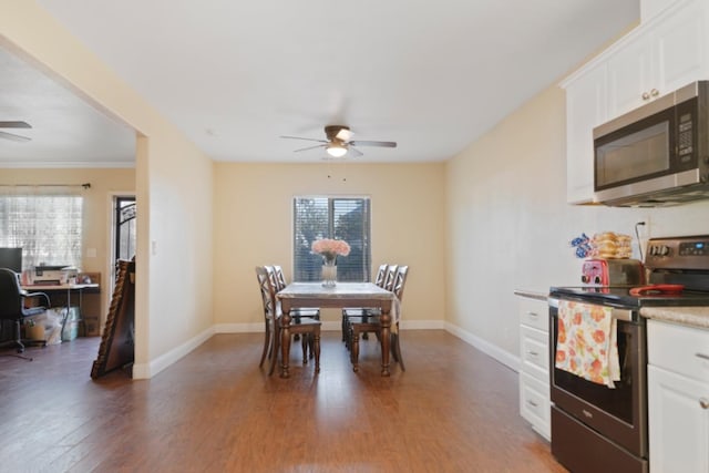 dining space with dark wood-type flooring, a wealth of natural light, and ceiling fan