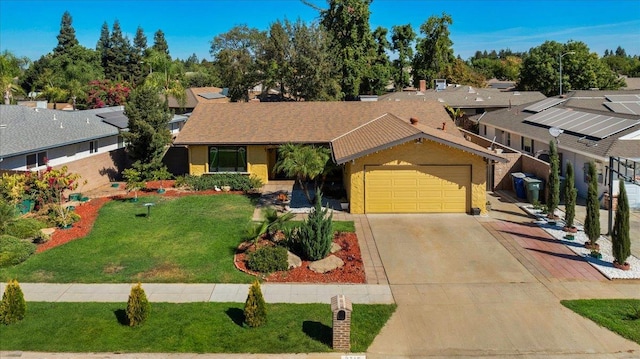 ranch-style house featuring a garage and a front yard