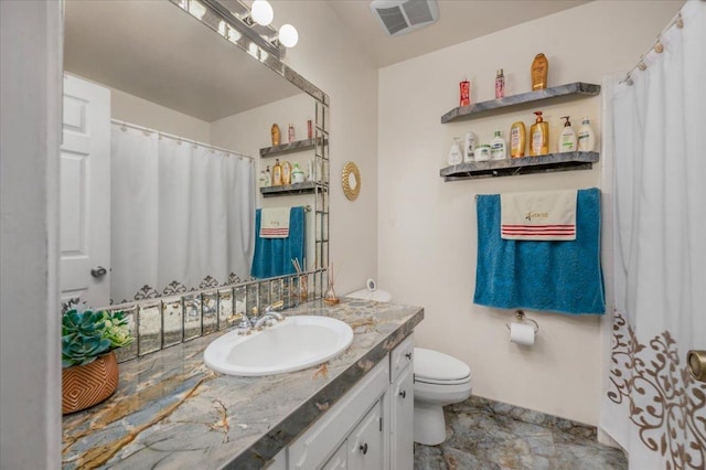 bathroom with toilet and vanity