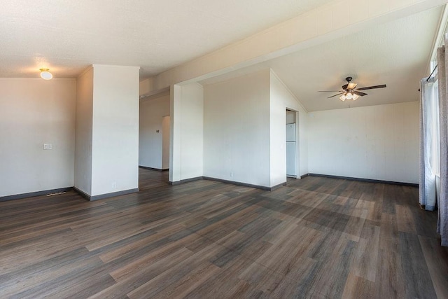 unfurnished room with ceiling fan, baseboards, and dark wood finished floors