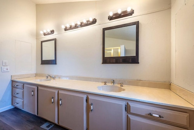 bathroom with visible vents, a sink, and double vanity