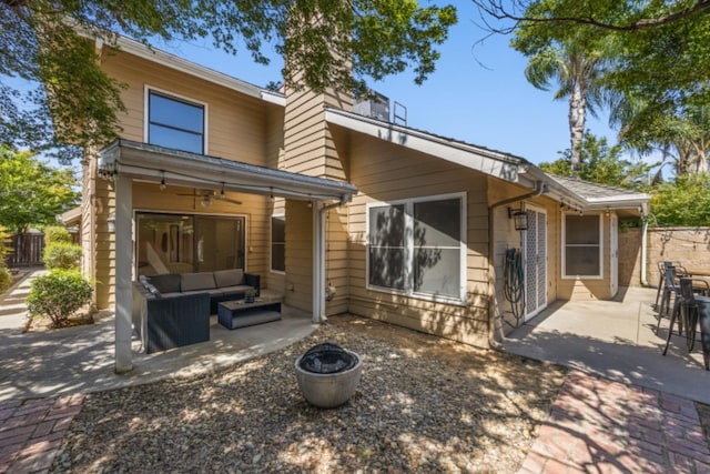 back of property featuring a patio area and an outdoor living space