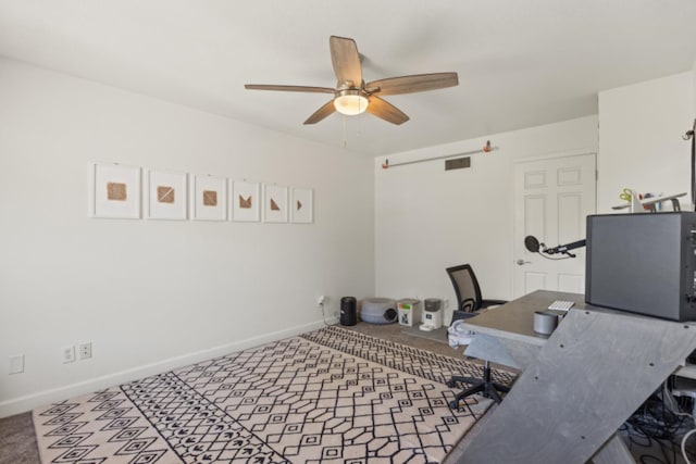 office space with carpet flooring and ceiling fan