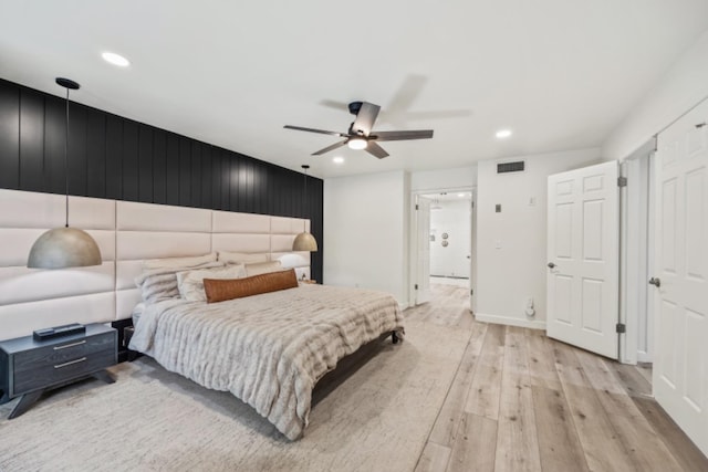 bedroom with ceiling fan and light hardwood / wood-style flooring