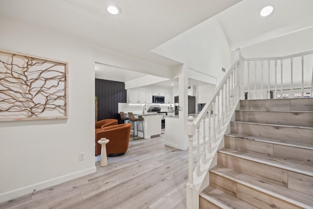 stairway featuring wood-type flooring