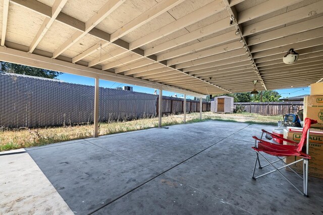 view of patio featuring a storage shed