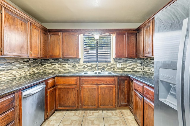 kitchen with light tile patterned flooring, backsplash, stainless steel appliances, and sink