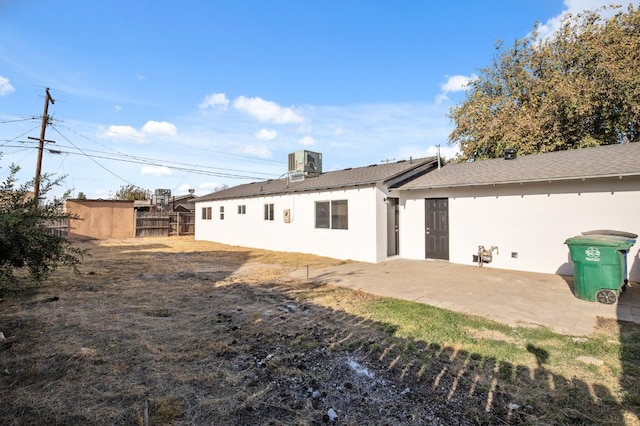 rear view of house with a patio area and central air condition unit