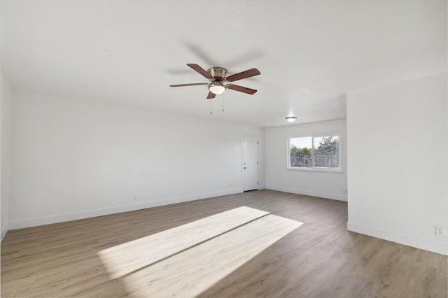 spare room with ceiling fan and light wood-type flooring